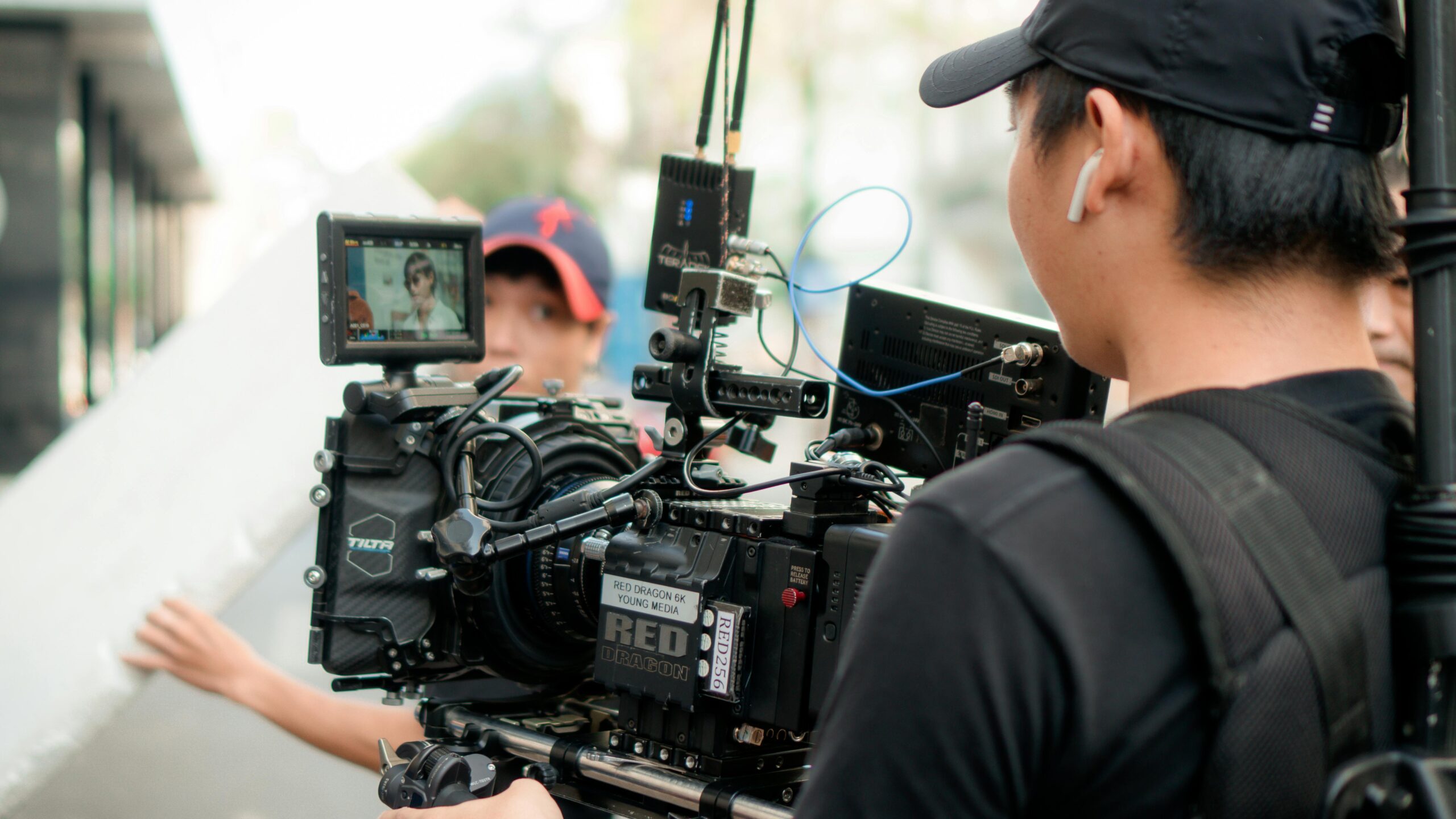 Cinematographer working with advanced film equipment on an outdoor set.